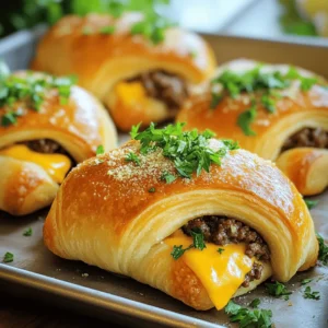 To make Garlic Parmesan Cheeseburger Bombs, you'll need these key ingredients: - 1 lb ground beef - 1 cup shredded sharp cheddar cheese - 1/2 cup finely grated Parmesan cheese - 1 clove garlic, minced - 1 teaspoon onion powder - 1 teaspoon Worcestershire sauce - 1 package (8 oz) refrigerated crescent roll dough - 1 tablespoon fresh parsley, finely chopped (for garnish) - Salt and freshly ground black pepper to taste - 1 tablespoon unsalted butter, melted - 1 tablespoon garlic powder - 1/2 teaspoon Italian seasoning These ingredients work together to create a cheesy, flavorful treat. The ground beef makes the bombs hearty. The cheeses add creaminess and richness. Garlic and spices give it that extra kick. You can play around with optional ingredients to enhance the taste. Here are some ideas: - Diced onions for more crunch and sweetness - Chopped jalapeños for heat - Cooked bacon bits for smokiness - Sriracha or hot sauce for a spicy twist Adding these can elevate your bombs to a new level. You can customize them to fit your taste and make them unique. Dipping sauces can make your Garlic Parmesan Cheeseburger Bombs even more fun. Here are some tasty options: - Ketchup for classic flavor - Ranch dressing for creaminess - Barbecue sauce for a smoky touch - Mustard for a tangy bite These sauces add different flavors and textures. They also let you enjoy the bombs in new ways. For the full recipe, check out the step-by-step guide to make these delicious bites. First, gather all your ingredients. You need ground beef, cheeses, garlic, and spices. Use fresh garlic for the best flavor. Chop the parsley finely for garnish later. Preheat your oven to 375°F (190°C) so it's ready when you are. Now, take a big mixing bowl. Combine the ground beef, minced garlic, onion powder, and Worcestershire sauce. Add salt and pepper to taste. Mix everything well. Then, form small patties, about the size of a tablespoon. Heat a skillet over medium heat. Cook each patty for 2-3 minutes on each side. They should be browned but not fully cooked. Set them aside to cool a bit. On a clean surface, unroll the crescent roll dough. You’ll find it in triangles. Place a spoonful of shredded cheddar cheese in the middle of each triangle. Then, add a cooked beef patty on top. Sprinkle more cheddar cheese and a bit of Parmesan on each patty. Fold the points of the dough over the filling. Pinch the edges tightly to seal each bomb. Make sure there are no gaps to keep all the goodness inside. Arrange the bombs on a greased baking sheet. Leave space between them for even cooking. In a small bowl, mix melted butter, garlic powder, and Italian seasoning. Brush this mix on top of each bomb. This adds flavor and helps them turn golden brown. Place the baking sheet in the oven. Bake for 12-15 minutes. They are done when they are puffy and golden. Let them cool for a few minutes before serving. Garnish with chopped parsley for a nice touch. Enjoy these tasty Garlic Parmesan Cheeseburger Bombs! For the full recipe, check out the earlier section. To make sure your bombs stay sealed, pinch the dough tightly. Gaps allow cheese and meat to escape during baking. If you find the dough is hard to work with, let it sit at room temperature for a few minutes. This makes it easier to handle. Always check your seals before baking. A good seal means a tasty treat! For the best results, place your bombs on a greased baking sheet. This helps them cook evenly and prevents sticking. Make sure to leave space between each bomb. They need room to expand as they bake. Bake them until they are golden brown. This usually takes about 12 to 15 minutes at 375°F. Keep an eye on them to avoid burning. To boost flavor, brush melted butter over the tops of the bombs before baking. Mix in garlic powder and Italian seasoning for extra taste. You can also add herbs like fresh parsley for a burst of freshness. For a crunchy texture, sprinkle some breadcrumbs on top before baking. These small steps can transform your bombs into a gourmet delight! For the full recipe, check the link above. {{image_4}} You can create a vegetarian version of Garlic Parmesan Cheeseburger Bombs. Use plant-based ground meat instead of beef. You can also mix in black beans or lentils for protein. Add diced bell peppers or mushrooms for extra texture and flavor. Make sure to season your mix well with garlic and onion powder. This way, each bite remains tasty and satisfying. Cheese is key to these bombs. While cheddar and Parmesan shine, try different cheeses too. Mozzarella adds a gooey texture. Pepper jack gives a spicy kick. You can even mix cheeses for depth. For a creamy touch, add a dollop of cream cheese. This creates a rich filling that melts beautifully. Want to spice things up? Add fun flavors to your bombs. Try a splash of barbecue sauce or hot sauce in the beef mix. Chopped herbs like basil or oregano can boost freshness. You can also mix in sautéed onions or jalapeños for an extra punch. These little tweaks will make your bombs unique and delicious. For the full recipe, you can check the earlier sections. To store leftover Garlic Parmesan Cheeseburger Bombs, let them cool first. Place them in a sealed container. Use parchment paper between layers to avoid sticking. Store in the fridge for up to three days. This keeps them fresh and tasty. When ready to eat, preheat your oven to 350°F (175°C). Place the bombs on a baking sheet. Bake for about 10 minutes, or until heated through. This method keeps the outside crispy. You can also microwave them, but they may become soft. To freeze, wrap each cheeseburger bomb in plastic wrap. Then, place them in a freezer bag. Be sure to remove as much air as possible. They can last up to three months in the freezer. When ready to cook, thaw in the fridge overnight before reheating. Enjoy the same delicious taste! Yes, you can use other meats. Ground turkey or chicken works well. You can also try plant-based meat for a vegetarian option. Each meat gives a unique flavor. Just make sure to adjust cooking times based on the meat you choose. To make these bombs gluten-free, swap the crescent roll dough for gluten-free dough. You can find premade options at most grocery stores. Also, check all your spices and sauces to ensure they are gluten-free. These bombs go great with a fresh salad or crispy fries. You can also serve them with coleslaw for extra crunch. A side of dipping sauces, like ketchup or ranch, adds a fun twist too. Yes, you can prep these bombs ahead of time. Make them and keep them in the fridge before baking. Just remember to bake them fresh when you're ready to serve. This keeps them warm and tasty. Garlic Parmesan Cheeseburger Bombs are easy and fun to make. We covered the main ingredients and ways to spice them up. You learned how to prep your ingredients and bake them perfectly. Don’t forget the tips for sealing and storage. Try the variations for a unique twist. These bombs are tasty, easy, and great for any meal. Now, it's time to gather your ingredients and create your own delicious batch today!