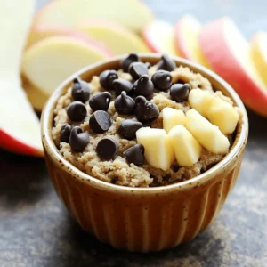 To make the best protein cookie dough, you need just a few key ingredients. Here’s what you need: - 1 cup almond flour - 1/2 cup vanilla protein powder - 1/4 cup almond butter or creamy peanut butter - 1/4 cup pure maple syrup or runny honey - 1/2 teaspoon vanilla extract - 1/4 cup mini dark chocolate chips - A pinch of sea salt - Optional: 1 tablespoon milk or plant-based milk These ingredients create a tasty and healthy base for your cookie dough. If you want to boost the flavor, you can add some fun extras. Try these options: - Chopped nuts like walnuts or pecans - Dried fruits such as cranberries or raisins - A sprinkle of cinnamon for warmth - Coconut flakes for a tropical twist These add-ins give your cookie dough unique flavors. Feel free to mix and match to find your favorite combo! Each ingredient in this cookie dough has great benefits: - Almond flour is full of healthy fats and protein. It’s also gluten-free. - Vanilla protein powder adds protein to help build muscle and keep you full. - Almond butter or peanut butter provides healthy fats and fiber for energy. - Maple syrup or honey offers natural sweetness. They have minerals and antioxidants. - Vanilla extract brings a lovely flavor without extra calories. - Mini dark chocolate chips add a touch of sweetness while being lower in sugar. - Sea salt enhances flavors and balances sweetness. Using these ingredients helps you create a treat that is not only delicious but also nutritious. For the full recipe, check out the details above! To make protein cookie dough, gather your ingredients first. You will need: - 1 cup almond flour - 1/2 cup vanilla protein powder - 1/4 cup almond butter or creamy peanut butter - 1/4 cup pure maple syrup or runny honey - 1/2 teaspoon vanilla extract - 1/4 cup mini dark chocolate chips - A pinch of sea salt - Optional: 1 tablespoon milk or plant-based milk Start by mixing the almond flour and protein powder in a bowl. Whisk them well to break any lumps. Next, add the almond butter and maple syrup to the dry mix. Use a spatula to combine everything. Mix until it looks crumbly but uniform. Then, pour in the vanilla extract and sprinkle the sea salt. Keep mixing until a dough starts to form. If it seems too dry, add the optional milk slowly. Just a teaspoon at a time until you reach your desired softness. Finally, fold in the mini dark chocolate chips. Make sure they are evenly spread throughout the dough. You can then shape the dough into small balls or leave it in a scoopable form. To get the best texture, make sure to whisk the dry ingredients well first. This helps the dough mix smoothly. When adding wet ingredients, do it slowly. This allows you to control the dough's moisture. If your dough is too sticky, just add a bit more almond flour. If it’s too dry, a little more milk will help. Always taste the dough to check if the sweetness is to your liking. Once your dough is ready, place it in a container and chill it in the fridge for about 30 minutes. This makes it easier to handle. After chilling, you can serve it in a small bowl. For an appealing look, top it with extra chocolate chips. You can also pair the dough with fresh fruit like apples or berries. This adds a nice touch to your healthy treat. Enjoy it straight from the bowl or share it with friends. Check out the Full Recipe for more details! When making protein cookie dough, you might face a few hiccups. Here are some common mistakes: - Using the wrong flour: Stick to almond flour for the best texture. - Overmixing the dough: Mix until just combined. Too much mixing makes it tough. - Not measuring accurately: Use a scale or measuring cups. Precision matters! - Skipping the chill time: Chilling helps the dough firm up. Don’t skip it! Proper storage keeps your protein cookie dough fresh. Here are my best tips: - Use an airtight container: This keeps moisture out and flavor in. - Label your container: Write the date on it. This helps you track freshness. - Refrigerate for up to a week: Enjoy your dough within this time for the best taste. - Freeze for longer storage: If you want to save it, freeze it in small portions. Want to spice up your cookie dough? Here are ways to boost its flavor and texture: - Add spices: A dash of cinnamon or nutmeg brings warmth and richness. - Mix in nuts: Chopped almonds or walnuts add crunch and flavor. - Use flavored protein powder: Chocolate or cookies and cream flavors can enhance taste. - Try different sweeteners: Swap maple syrup for agave or honey for a unique twist. You can find the full recipe for making this delightful treat above! Enjoy experimenting with these tips! {{image_4}} You can easily change the flavor of your protein cookie dough. Try adding different flavors of protein powder. Chocolate or cookies and cream can create a tasty twist. You can also mix in spices like cinnamon or nutmeg. These spices add warmth and depth. For a fruity touch, fold in dried cranberries or chopped dates. Both add natural sweetness and chewiness. If you need a nut-free version, use sunflower seed butter instead of almond butter. It gives a similar creamy texture. Swap almond flour for oat flour for a nut-free base. For a dairy-free option, use a plant-based protein powder. Coconut flour can add a nice coconut flavor if you like that taste. Want to make your cookie dough even healthier? Add superfoods! Chia seeds or flaxseeds boost fiber and omega-3 fatty acids. You can also mix in hemp seeds for extra protein. If you like chocolate, try adding cacao nibs for a rich flavor. These little gems add crunch and nutrients. You can find them at most grocery stores. You can enjoy these variations to make your protein cookie dough fun and unique. Try the full recipe to start creating your own favorite flavors today! To keep your protein cookie dough fresh, place it in an airtight container. This will help to lock in moisture and flavor. If you plan to eat it within a week, store it in the fridge. The cool temperature will keep the dough firm and tasty. If you want to save some for later, freezing is a great option. First, shape the dough into small balls or leave it in a scoopable form. Then, place them on a baking sheet lined with parchment paper. Freeze for about two hours until firm. After that, transfer the dough balls to a freezer-safe bag. They can last for up to three months in the freezer. When you are ready to enjoy your frozen cookie dough, take out the desired amount. Let it thaw in the fridge for a few hours. If you are short on time, you can also thaw it at room temperature for about 30 minutes. Once thawed, it’s ready to eat! You can enjoy it straight from the bowl or use it in recipes. For the full recipe, check out my detailed guide. Protein Cookie Dough is a great snack for many reasons. First, it has protein from the protein powder and nut butter. Protein helps build muscles and keep you full. Second, it uses almond flour instead of regular flour. Almond flour is low in carbs and high in good fats. It gives you energy without the crash. Third, this dough has no refined sugars. It uses maple syrup or honey, which are natural sweeteners. This makes it a better choice for your body. You get a treat that tastes good and supports your health goals. You will know your cookie dough is ready when it holds together well. After mixing, it should feel soft but not sticky. If it crumbles too much, try adding a bit of milk. When you shape it into balls, it should keep its form. If it falls apart, mix it a bit more. After chilling for 30 minutes, the dough firms up. This makes it easier to scoop or shape. Taste a little, and if it’s sweet and creamy, it's ready to enjoy. Yes, you can use different types of protein powder! Each kind may change the taste a bit. For example, chocolate protein powder can give your dough a rich flavor. Plant-based protein powders work well too. Just make sure to check the taste and adjust the sweetness. If you prefer vegan options, look for plant-based protein. You can also mix different powders for a unique flavor. Experimenting will help you find your favorite combo! In this blog post, we explored how to make protein cookie dough. We covered key ingredients and tasty add-ins for flavor. You learned about easy steps for prep and mixing, plus tips for chilling and serving. We also discussed common mistakes to avoid and how to store your dough. In closing, protein cookie dough is a fun, healthy snack. Experiment with flavors and enjoy your homemade treats!