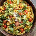 - 8 oz rotini pasta - 2 cups corn kernels (fresh or frozen) - 1/2 cup cherry tomatoes, halved - 1/4 of a red onion, finely chopped - 1 ripe avocado, diced - 1/2 cup cotija cheese, crumbled - 1/4 cup fresh cilantro, chopped - 2 tablespoons fresh lime juice - 2 tablespoons extra virgin olive oil - 1 teaspoon chili powder - 1/2 teaspoon garlic powder - Salt and freshly ground black pepper, to taste To make this Mexican street corn pasta salad, gather all the ingredients first. Using fresh corn adds a sweet crunch. If you use frozen corn, it works well too. The rotini pasta holds the dressing nicely. Cherry tomatoes bring a juicy burst of flavor. The red onion adds a slight bite, while the avocado gives creaminess. Crumbled cotija cheese adds a salty kick. Fresh cilantro brightens every bite. The lime juice brings a tangy zest. Olive oil helps blend all the flavors. Chili powder gives a little warmth. Garlic powder adds depth. Don’t forget salt and pepper to taste. With these ingredients, you can create a vibrant, tasty salad. Each bite will remind you of the street vendors in Mexico. Enjoy the mix of textures and flavors! To start, boil a large pot of salted water. Once it’s bubbling, add 8 oz of rotini pasta. Cook it until al dente, as per the package guide. When done, drain the pasta in a colander. Rinse it under cold water to cool it. This step stops the cooking and keeps the pasta firm. Next, heat a bit of olive oil in a medium skillet over medium heat. Toss in 2 cups of corn kernels. Sauté for about 5-7 minutes. Keep stirring until the corn gets slightly charred. This adds great flavor! After cooking, remove the skillet from the heat and let the corn cool down. In a large bowl, combine the cooled pasta and sautéed corn. Now, add 1/2 cup of halved cherry tomatoes, 1/4 of a finely chopped red onion, and 1 ripe diced avocado. Sprinkle in 1/2 cup of crumbled cotija cheese and 1/4 cup of chopped fresh cilantro. Gently mix these ingredients together. For the dressing, take a small bowl. Whisk together 2 tablespoons of fresh lime juice, 2 tablespoons of olive oil, 1 teaspoon of chili powder, and 1/2 teaspoon of garlic powder. Add a pinch of salt and freshly ground black pepper. Mix until smooth. This dressing packs a punch! Now, drizzle the dressing over the salad. Gently toss everything together. Be careful not to mash the avocado while mixing. You want to keep its nice chunks intact. You can serve the salad right away for a fresh taste. Or, for better flavor, chill it in the fridge for about 30 minutes. This waiting time lets the ingredients blend nicely. For a pretty presentation, use a large bowl and add extra cilantro on top. A lime wedge will let your guests add a zesty touch! To cook the pasta perfectly, start with a large pot. Fill it with water and add salt. Bring the water to a rolling boil. Add the rotini pasta and cook it until it is al dente. This means it should be firm but not hard. Drain the pasta in a colander and rinse it under cold water. This stops the cooking. Let it cool completely before mixing. For the corn, use a medium skillet and add a drizzle of olive oil. Heat it over medium heat. Add the corn kernels and sauté them for about 5 to 7 minutes. Stir them often to get that lovely char. You want them to be golden and slightly crispy. Once done, take the skillet off the heat and let the corn cool. When serving the salad, choose a large, colorful bowl. This makes the dish look bright and inviting. You can garnish it with extra chopped cilantro on top. Add a wedge of lime on the side. This lets your guests squeeze fresh lime juice over their servings, bringing even more flavor. To boost the flavors in your salad, consider marinating the ingredients. Once you mix the salad, cover it and let it sit in the fridge for about 30 minutes. This allows all the flavors to blend well. The lime juice and spices will soak into the pasta and corn, making every bite tastier. {{image_4}} You can change the rotini pasta for other types. Penne or fusilli work well too. These pasta shapes hold the salad ingredients nicely. For cheese, cotija is great, but you can use feta or queso fresco. Both have a salty flavor that pairs well with the salad. Want more heat? Add jalapeños or cayenne pepper. Start with a small amount, then taste. You can always add more spice as needed. If you prefer it milder, skip the chili powder or use a sweet paprika. This will keep the flavor bright without the heat. To make this salad vegan, swap out the cotija cheese. Use a vegan cheese or skip it entirely. Instead of lime juice, try using apple cider vinegar for a tangy kick. Replace the honey with agave syrup if you want a touch of sweetness. This way, you still enjoy a fresh and tasty salad while sticking to your diet. To keep your Mexican street corn pasta salad fresh, store it in an airtight container. Place the salad in the fridge if you plan to eat it within 1-2 days. The cool temperature slows spoilage. Make sure to cover the salad well. This prevents air from making it dry. For longer storage, you can freeze the salad. However, pasta and avocado do not freeze well. To freeze, remove any avocado and store the remaining salad mix in a freezer-safe container. When you’re ready to enjoy it, thaw it in the fridge overnight. Once thawed, add fresh avocado and mix well before serving. Watch for signs that your salad has spoiled. Look for any off smells, changes in color, or slimy textures. If you see any of these signs, it’s best to toss the salad. To prevent spoilage, make sure to use fresh ingredients and store it promptly after serving. Keeping the salad covered in the fridge helps maintain its quality longer. Yes, you can make this salad ahead of time. It stores well in the fridge. I recommend making it a few hours before your meal. This gives the flavors time to blend. To store, place it in an airtight container. Keep it in the fridge until ready to serve. If you want to make it even earlier, you can prepare the pasta and corn the day before. If you can't find cotija cheese, try feta cheese. Feta offers a similar crumbly texture and salty taste. You can also use queso fresco for a milder flavor. Another option is Parmesan, but it adds a different taste. Each cheese will change the salad's flavor a bit, so pick one that you like! This salad stays fresh for about 2-3 days in the fridge. Use an airtight container to keep it fresh longer. After a day, the vegetables may become a bit soggy. You can always add fresh toppings like avocado or cilantro right before serving. If you see any signs of spoilage, like a bad smell or slimy texture, it's best to toss it. Yes, you can make this recipe gluten-free. Simply use gluten-free rotini pasta. There are many options available, like chickpea or brown rice pasta. These options have different tastes but work well in this salad. Just make sure to follow the cooking instructions on the package for the best results. Absolutely! You can add grilled chicken for a hearty meal. Shrimp also makes a great addition if you like seafood. For a vegetarian option, try adding black beans or chickpeas. These proteins will make the salad more filling and add extra flavor. This blog post shared a tasty and easy salad recipe. We covered all the ingredients, from pasta to corn, plus dressings and tips for great flavor. You can mix it up with different ingredients and spices to fit your taste. Remember, this salad is fresh and perfect for any meal. With proper storage, it can last a few days too. Try making this salad your own. Enjoy the fun of cooking and sharing with friends!