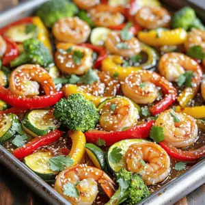 - 1 lb (450g) large shrimp, peeled and deveined - 2 tablespoons honey - 3 tablespoons low sodium soy sauce - 3 cloves garlic, finely minced - 1 teaspoon fresh ginger, grated - 1 red bell pepper, diced - 1 yellow bell pepper, diced - 1 medium zucchini, sliced into half-moons - 1 cup broccoli florets - 2 tablespoons olive oil - Salt and freshly cracked black pepper to taste - 1 tablespoon sesame seeds (for garnish) - Fresh cilantro or parsley, chopped for garnish - The shrimp should be large for a nice bite. - Use two tablespoons of honey for the perfect sweetness. - Three tablespoons of soy sauce adds the needed saltiness. - Use three cloves of garlic for strong flavor. - One teaspoon of fresh ginger gives a warm taste. - Diced bell peppers add color and crunch. - One medium zucchini works well for texture. - One cup of broccoli florets brings nutrition and green color. - Use two tablespoons of olive oil to help veggies roast. - Salt and black pepper should be used to taste. - Sesame seeds and fresh herbs are for garnish. - You can swap shrimp with chicken or tofu if you prefer. - Agave syrup or maple syrup can replace honey for a vegan option. - Tamari can be a gluten-free substitute for soy sauce. - Garlic powder can replace fresh garlic in a pinch. - Any crunchy vegetables, like carrots or snap peas, can work. - Use any cooking oil in place of olive oil, like avocado oil. - You can skip sesame seeds and herbs if you don’t have them. Start by preheating your oven to 400°F (200°C). This step is key for roasting. A hot oven helps the shrimp cook fast and keeps the veggies crisp. In a medium bowl, mix honey, soy sauce, minced garlic, and grated ginger. Whisk it well. Next, add the shrimp and toss to coat. Let them marinate for about 15 minutes. This makes the shrimp tasty and flavorful. While the shrimp marinates, take a large sheet pan. Spread out the diced red and yellow bell peppers, sliced zucchini, and broccoli florets. Drizzle with olive oil. Season with salt and fresh black pepper. Toss to mix, then arrange the veggies in a single layer. This helps them roast evenly. After the shrimp has marinated, place them evenly over the veggies on the pan. Drizzle any leftover marinade over both. This adds more flavor to the dish. Put the sheet pan in your preheated oven. Roast for about 15-20 minutes. Check that the shrimp are opaque and cooked through. The veggies should be tender but still a bit crisp. When done, take the pan out of the oven. Sprinkle with sesame seeds and chopped cilantro or parsley. This adds color and freshness. Serve right from the sheet pan for a casual feel, or place on individual plates for a nicer look. A wedge of lime on the side can also brighten the dish. Cooking times can vary with your oven. If your shrimp are larger, add a few extra minutes. You can check if they are done by looking for their pink color. If the shrimp is opaque, they are ready to eat. For veggies, they should be tender but still crisp. If they need more time, keep them in the oven for a few extra minutes. To get the best shrimp, don’t overcook them. They cook fast, usually in about 15 to 20 minutes. Start checking them at the 15-minute mark. If you see the shrimp turning pink and curling slightly, they are done. Remove them quickly to avoid rubbery shrimp. You can boost the flavor in many ways. Add more garlic or ginger to the marinade for a stronger taste. A dash of red pepper flakes adds heat. Lemon juice or lime juice can brighten up the dish nicely. If you want a sweet twist, mix in a bit of orange juice. Garnishing with fresh herbs like cilantro or parsley adds a fresh touch. {{image_4}} You can mix in other veggies to make this dish your own. Try adding snap peas, carrots, or asparagus. You can even use cauliflower or mushrooms for a unique twist. Just make sure to cut them into similar sizes for even cooking. This way, every bite has a mix of flavors and textures. The key is to balance the dish with colorful options that roast well. If you like heat, try adding chili flakes or a diced jalapeño to the marinade. You can also use sriracha or a spicy garlic sauce. Start with a small amount and taste as you go. This way, you can control the heat level. The spice will add a fun kick to the sweet honey and garlic flavors. Your taste buds will thank you! Switching up the sauce can give this dish a whole new vibe. Use teriyaki sauce for a sweet and savory twist. You could also try a citrus marinade with orange juice and zest. This will brighten the dish and add a fresh taste. Another option is a peanut sauce for a nutty flavor. Just remember to adjust the cooking time if you add thicker sauces. Each choice will make your honey garlic shrimp and veggies feel new and exciting! After cooking, let the honey garlic shrimp and veggies cool down. Store leftovers in an airtight container. They can stay fresh in the fridge for up to three days. When storing, separate the shrimp from the veggies if possible. This helps keep both items fresh longer. If you want to keep the dish longer, freezing is a great option. Place the cooled shrimp and veggies in a freezer-safe container. Make sure to remove as much air as you can. This helps prevent freezer burn. You can freeze them for up to two months. When you’re ready to eat, thaw them in the fridge overnight. To reheat, you have a few options. The oven works best to keep everything crispy. Preheat it to 350°F (175°C). Spread the shrimp and veggies on a baking sheet. Heat for about 10-15 minutes or until warm. You can also use a microwave for quick heating. Just place them in a microwave-safe bowl and heat in short bursts, stirring in between. Yes, you can use frozen shrimp for this recipe. Just make sure to thaw them first. I recommend placing the shrimp in the fridge overnight. If you need to thaw them faster, place the shrimp in a bowl of cold water for about 15-20 minutes. Once thawed, pat them dry with a paper towel before marinating. This helps the marinade stick better and makes the shrimp tasty. To make this dish gluten-free, swap the low sodium soy sauce with tamari or coconut aminos. Both options work well and keep the flavors intact. Double-check all your ingredients to ensure they are gluten-free. The rest of the recipe stays the same, so you still get that sweet and savory kick! Several sides go perfectly with honey garlic shrimp. Here are some great options: - Steamed rice or cauliflower rice for a low-carb choice. - Quinoa for a healthy grain option. - A fresh green salad with a light vinaigrette. - Garlic bread to soak up the delicious sauce. These sides enhance the meal and balance the flavors of the shrimp and veggies. Enjoy your cooking! In this post, we explored the ingredients needed for honey garlic shrimp, including their measurements and possible substitutes. I provided step-by-step instructions for marinating and roasting shrimp and veggies. We discussed tips for perfect cooking and creative variations to customize your dish. Finally, I shared storage info and answered common questions. Remember, cooking is fun and easy. You can make this recipe your own. Enjoy your dish, and feel proud of your tasty creation!