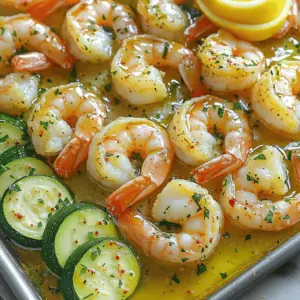 - 1 pound large shrimp, peeled and deveined - 2 medium zucchinis, sliced into half-moons - 4 cloves garlic, finely minced - 1/4 cup unsalted butter, melted - 2 tablespoons extra virgin olive oil - 1 teaspoon freshly grated lemon zest - 1 tablespoon fresh lemon juice - 1 teaspoon smoked paprika - 1 teaspoon dried oregano - Salt and freshly ground black pepper, to taste - Fresh parsley, finely chopped (for garnish) This dish shines with its simple yet bold flavors. The shrimp brings a sweet briny taste, while the zucchini adds a fresh crunch. Garlic, lemon, and spices elevate the dish, making it truly memorable. When choosing shrimp, go for large ones. They cook quickly and have a nice bite. Zucchini is best when firm and bright. The garlic should be fresh to give the most flavor. You can swap in other ingredients, too. Try bell peppers or asparagus for a different twist. - Preheat oven to 400°F (200°C) - Line baking sheet with parchment paper Start by heating your oven. This step ensures your shrimp and zucchini cook evenly. While the oven warms, cover your baking sheet with parchment paper. This makes cleanup easier and stops sticking. - Combine melted butter, olive oil, minced garlic, lemon zest, lemon juice, smoked paprika, oregano, salt, and pepper Next, make the garlic butter mixture. In a large bowl, mix melted butter and olive oil. Add minced garlic, lemon zest, and lemon juice. Then, sprinkle in smoked paprika and oregano. Finish with salt and pepper. Whisk everything together until it smells great. - Toss shrimp in garlic butter mix and marinate for 15 minutes - Lightly drizzle zucchini with olive oil, salt, and pepper Now, it’s time to marinate the shrimp. Add them to the garlic butter mix and toss gently. Let them sit for 15 minutes. This helps the shrimp soak up all the flavors. While they marinate, grab your zucchini. Drizzle it with olive oil and sprinkle with salt and pepper. Toss to coat them well. - Place zucchini on one side and shrimp on the other side of the baking sheet Once the shrimp are ready, arrange the zucchini on one side of your baking sheet. Place the marinated shrimp on the other side. Keep them separate to cook properly. - Bake for 10-12 minutes until shrimp are pink and zucchini is tender Put the baking sheet in the oven. Bake for 10-12 minutes. The shrimp will turn pink and opaque, while the zucchini becomes tender. Keep an eye on them! - Garnish with fresh parsley before serving When done, take the sheet out of the oven. Sprinkle fresh parsley on top. This adds a nice touch and enhances the dish’s look. Your sheet pan garlic butter shrimp and zucchini is now ready to enjoy! Marinating shrimp is key. It adds flavor and keeps them moist. Use the garlic butter mix for this. Let them sit for 15 minutes. This short time helps the shrimp soak up the taste. For the best texture, choose large shrimp. They stay juicy and cook evenly. Do not overcook them. When shrimp turn pink and opaque, they are done. Watch closely to avoid rubbery shrimp. Slice zucchini into half-moons. This shape helps them cook evenly. Aim for uniform pieces to ensure they roast well together. Season the zucchini with olive oil, salt, and pepper. This simple mix enhances its natural flavor. Toss the slices gently for even coating. Cook them until tender and slightly caramelized. This adds a nice sweetness to the dish. For a stunning presentation, use a large, shallow bowl. Arrange the shrimp and zucchini side by side. Drizzle any leftover garlic butter on top. This adds flavor and makes the dish shine. Pair this meal with a light white wine or iced tea. A fresh salad on the side complements the dish nicely. Enjoy the burst of flavors and beautiful colors! {{image_4}} Cooking is all about creativity. You can easily change this dish to fit your taste. Here are some fun variations to try. You can swap shrimp for other proteins. Chicken works great in this recipe. Use boneless, skinless chicken thighs or breasts. Scallops are another tasty option. They cook quickly and have a sweet flavor. You can also change the veggies. Try bell peppers for a sweet crunch. Asparagus adds a nice green touch. Broccoli or carrots could work too. Mix and match to find your favorite combo! Want more flavor? Add extra seasonings. A pinch of garlic powder or onion powder can boost taste. Fresh herbs like thyme or basil also add depth. If you like heat, sprinkle in some chili flakes. They add a spicy kick that pairs well with shrimp. You can also use hot sauce for a zesty twist. This dish can fit many diets. For gluten-free needs, just check your butter and seasonings. Most are naturally gluten-free. If you follow a low-carb or ketogenic diet, this dish is perfect. Shrimp and zucchini are low in carbs. You can replace the butter with a healthy fat like avocado oil. Enjoy a tasty meal that meets your dietary needs! To keep shrimp and zucchini fresh, store them in an airtight container. Place them in the fridge right after your meal. Leftovers will stay good for up to three days. Make sure to cool the dish down before sealing it. When reheating, use the oven or stovetop. The oven keeps the shrimp and zucchini from getting soggy. Heat at 350°F (175°C) for about 10 minutes. If using the stovetop, warm gently over low heat. To avoid overcooking the shrimp, heat just until warm. Shrimp cook fast, so keep an eye on them. Yes, this dish can be frozen! To freeze, place the leftovers in a freezer-safe container. Leave some space for expansion. Label it with the date and eat within three months. When you’re ready to eat, thaw it overnight in the fridge. Reheat as mentioned above for the best taste. To devein shrimp, first, use a sharp knife. Make a cut along the back of the shrimp. You will see a dark vein. This is the digestive tract. Carefully pull it out with your fingers or the knife. Rinse the shrimp under cold water afterward. This method is quick and keeps your shrimp clean and fresh. Yes, you can use frozen shrimp. Just make sure to thaw them first. Place the shrimp in a bowl of cold water. Let them sit for about 15-20 minutes. If you have more time, leave them in the fridge overnight. After thawing, pat them dry with paper towels before cooking. This helps ensure they cook evenly. Absolutely! This recipe works well for meal prep. You can cook a larger batch and store it. Place the shrimp and zucchini in airtight containers. They will last in the fridge for up to three days. Just reheat them in the oven or microwave before serving. This makes it easy to enjoy a tasty meal later. You can serve this dish with many sides. Here are a few ideas: - Rice: White or brown rice pairs well. - Quinoa: A healthy, protein-packed option. - Salad: A fresh mixed green salad adds crunch. - Bread: Crusty bread is great for soaking up garlic butter. These sides will complement the shrimp and zucchini nicely. Shrimp are fully cooked when they turn pink and opaque. They should also curl slightly into a C shape. If they remain gray or translucent, they need more time. Be careful not to overcook them. Overcooked shrimp can become tough and rubbery, which is not pleasant. This recipe for sheet pan garlic butter shrimp and zucchini is simple and tasty. You learned about the key ingredients, easy steps, and helpful tips. Remember to marinate the shrimp for the best flavor and texture. You can also mix in different veggies or proteins to make it your own. Enjoy this dish warm, and don’t forget to pair it with your favorite sides. With fresh ingredients and straightforward steps, you can create a delicious meal that family and friends will love.