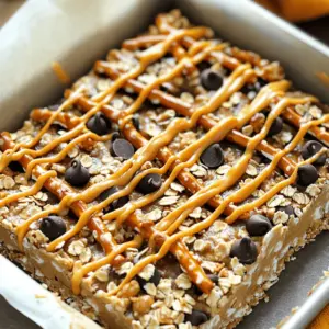 To make these no-bake peanut butter pretzel bars, you will need: - 1 ½ cups crushed pretzels - 1 cup peanut butter - ½ cup honey or maple syrup - 2 cups rolled oats - 1 cup chocolate chips - ½ teaspoon salt - ½ teaspoon vanilla extract - ¼ cup mini chocolate chips for topping (optional) These ingredients create a perfect mix of sweet and salty. The pretzels add crunch, while the peanut butter binds everything together. You can easily switch things up! Use almond or cashew butter instead of peanut butter. Try agave syrup or brown sugar for different sweetness. For a nut-free version, sunflower seed butter works great. Want to add a bit more flair? Sprinkle some sea salt on top for a salty kick. You can also drizzle melted chocolate or caramel over the bars. Chopped nuts or dried fruit can give extra texture and taste. Start by crushing 1 ½ cups of pretzels. You can use a rolling pin or your hands to do this. Place the crushed pretzels in a large bowl. Next, add 2 cups of rolled oats to the bowl. Mix them well with a spoon. This blend creates a crunchy base for your bars. In a small saucepan, combine 1 cup of peanut butter, ½ cup of honey or maple syrup, ½ teaspoon of salt, and ½ teaspoon of vanilla extract. Heat this over low flame. Stir the mix often until it is smooth. Avoid boiling it. This mixture gives your bars a sweet and nutty flavor. Once your peanut butter mix is ready, pour it over the pretzel and oat mixture. Stir well until everything is coated. Next, gently fold in 1 cup of chocolate chips. Line an 8x8 inch baking pan with parchment paper. Pour the mixture into the pan and press it down firmly. If you want, sprinkle ¼ cup of mini chocolate chips on top. Press them in lightly. Place the pan in the fridge for at least 2 hours. This helps the bars firm up. After they set, lift them out and cut them into squares. Enjoy your tasty treat! Mixing is key to great bars. Start with dry ingredients. Combine crushed pretzels and oats first. This helps them mix well. Then, warm the peanut butter mix in a saucepan. Stir it until smooth. Pour this over the dry mix. This ensures even coating. Use a spatula to fold in the chocolate chips last. This keeps them from breaking. Peanut butter adds flavor and texture. You can choose creamy or crunchy. Creamy peanut butter gives a smooth bite. Crunchy peanut butter adds a fun crunch. Look for natural options with no added sugars or oils. This choice boosts the bars' taste and health. Serve these bars chilled for the best taste. Cut them into fun shapes for kids. Pair them with a glass of cold milk. This makes a tasty snack or dessert. You can also wrap them individually for on-the-go treats. These bars are fun to share at parties or picnics! {{image_4}} You can make these bars gluten-free by using gluten-free pretzels. Many brands offer great options that taste just as good. Check the label to ensure they are certified gluten-free. You can also swap out the oats for gluten-free rolled oats. This simple change keeps your bars tasty and safe for those with gluten issues. To make these bars vegan, use maple syrup instead of honey. Maple syrup is a great sweetener that works well in this recipe. For the chocolate chips, look for vegan chocolate chips. They taste amazing and keep the bars plant-based. Using these swaps makes the bars suitable for everyone! You can jazz up your bars with some fun flavors! Try adding a pinch of cinnamon for warmth. You might also enjoy a dash of sea salt on top for a sweet-salty mix. If you want, mix in nuts or seeds for extra crunch. Dried fruit can also add sweetness and chewiness. Get creative and make these bars your own! To keep your no-bake peanut butter pretzel bars fresh, store them in an airtight container. You can layer the bars with parchment paper to prevent them from sticking together. Place the container in the fridge. This way, they stay cool and firm. These bars last about one week in the fridge. If you want them to last longer, try freezing them. Wrap each bar tightly in plastic wrap. Then, place them in a freezer-safe bag. They can stay in the freezer for up to three months. When you want to eat one, thaw it in the fridge overnight. These bars are best enjoyed cold or at room temperature. If you prefer them warm, you can microwave a bar for about ten seconds. This will soften the chocolate and make it gooey. Just be careful not to overheat, as they can lose their shape. Enjoy every bite! Yes, you can use other nuts! Almonds, walnuts, or cashews work well. Just chop them up small. This adds different flavors and textures. If you like crunch, choose nuts that are roasted. You can even mix nuts for more variety. Just keep in mind that each nut has a unique taste. Experiment to find your favorite blend! To keep your bars from sticking, use less peanut butter or honey. Try adding more oats to the mix. This extra bulk helps absorb moisture. Make sure to press the mixture firmly into the pan. A well-packed layer reduces stickiness. You can also chill the bars longer. The colder they are, the firmer they will be! Yes, these bars are great for making ahead! You can prepare them up to a week in advance. Just store them in the fridge. Cut them into bars only when you are ready to serve. This keeps them fresh and tasty. Wrap them in plastic or keep them in an airtight container to prevent drying out. In this post, I shared how to make tasty no-bake peanut butter pretzel bars. We covered key ingredients, simple steps, and useful tips to enhance your bars. You can even try different flavors and toppings to suit your taste. These bars are easy to make and fun to enjoy. Experiment with variations and find what you love best. With the right storage, they stay fresh and delicious. Enjoy creating your perfect treat!