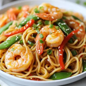 - 8 oz lo mein noodles - 1 lb large shrimp, peeled and deveined - 1 red bell pepper, julienned - 1 cup snap peas - 1 cup baby bok choy, chopped Lo mein noodles are the star here. They are soft and chewy. You can find them in most grocery stores. Large shrimp bring a sweet and tender bite. Peel and devein them for the best taste. Fresh vegetables add color and crunch. Red bell pepper gives sweetness, while snap peas add a snap. Baby bok choy adds a slight bitterness and great texture. - 1 tablespoon sesame oil - 2 tablespoons soy sauce - 1 tablespoon oyster sauce (optional) Sesame oil gives a warm, nutty flavor. It&rsquo;s key in Asian cooking. Soy sauce adds saltiness and depth. Use low-sodium if you prefer less salt. Oyster sauce adds a rich umami flavor. It&rsquo;s optional but highly recommended for more taste. - 1 teaspoon fresh ginger, grated - 2 garlic cloves, minced - 3 green onions, sliced - Sesame seeds for garnish Fresh ginger brings a spicy warmth. It wakes up the dish. Garlic adds a strong, savory note. Both should be saut&eacute;ed until fragrant. Green onions add a fresh crunch on top. Finally, sesame seeds are a beautiful garnish. They add a slight crunch and nutty flavor. This mix of ingredients creates a balance of flavors that makes each bite delicious. {{ingredient_image_2}} Start cooking the lo mein noodles. Follow the package instructions closely. Once they reach the right texture, drain them well. Set them aside for later. This step is key, as the noodles hold the dish together. Next, heat 1 tablespoon of sesame oil in a large skillet. Use medium-high heat until the oil shimmers. This heat brings out the nutty flavor. Now, add 2 minced garlic cloves and 1 teaspoon of grated fresh ginger. Saut&eacute; this mixture for about 1 minute. You want the garlic to be fragrant, not burned. Now it&rsquo;s time for the shrimp. Add 1 pound of peeled and deveined shrimp to the skillet. Cook them for about 2 to 3 minutes. Stir frequently, watching for color change. The shrimp should turn pink and opaque. That&rsquo;s how you know they&rsquo;re done. Remove them from the skillet and set them aside. In the same skillet, add 1 julienned red bell pepper and 1 cup of snap peas. Stir-fry these for about 3 to 4 minutes. You want them to soften but still be crunchy. Next, toss in 1 cup of chopped baby bok choy. Keep stir-frying for another 2 to 3 minutes until it wilts. Return the cooked shrimp to the skillet. Add the drained lo mein noodles next. Pour in 2 tablespoons of soy sauce and 1 tablespoon of oyster sauce if you choose. Toss everything together until well mixed and heated through. Taste and season with salt and pepper. Finally, garnish with sliced green onions and sesame seeds before serving. Enjoy your colorful and tasty meal! To get the best texture for shrimp, choose large, fresh shrimp. They cook evenly and stay juicy. When prepping shrimp, first peel and devein them. Rinse them under cold water to remove any grit. Pat them dry with a paper towel to help them sear nicely in the pan. This step is key for that delightful bite. You can mix in other fresh vegetables like carrots, broccoli, or bell peppers. Each adds a unique crunch and flavor. Fresh produce gives you the best taste and nutrition. Frozen veggies are a good backup when fresh ones are not available. They save time and still work well. Just be sure to thaw them before cooking to avoid extra water in your dish. For extra flavor, consider using different sauces. Try teriyaki or hoisin sauce for a twist. Add fresh herbs like cilantro or basil to brighten the dish. Spices such as red pepper flakes can add heat. Experiment with these options to find your favorite flavor combo. Each choice enhances your meal and makes it uniquely yours. Pro Tips Use Fresh Ingredients: Fresh shrimp and vegetables will enhance the flavor and texture of your dish, making it more vibrant and delicious. Don&rsquo;t Overcook the Shrimp: Cook the shrimp just until they turn pink to avoid a rubbery texture. They cook quickly, so keep an eye on them! Customize Your Veggies: Feel free to swap in your favorite vegetables like carrots, broccoli, or mushrooms to suit your taste or what you have on hand. Enhance with Heat: If you like a bit of spice, add some red pepper flakes or sriracha when combining the ingredients for an extra kick! {{image_4}} You can switch shrimp for chicken, beef, or tofu. Each option offers a unique taste. If you use chicken, cut it into small pieces. Cook it for about 5-7 minutes until it's no longer pink. For beef, thin slices work best. Cook it for about 3-4 minutes until browned. Tofu is great for a meat-free meal. Just make sure to press it first to remove excess water. Cook tofu until golden, about 5-6 minutes. To make this dish vegan, swap shrimp for tofu or tempeh. Use soy sauce instead of oyster sauce for depth. Add more veggies like carrots or mushrooms to boost nutrition. Ensure you use vegetable broth for added flavor. You want a balance of sweet, salty, and umami. A splash of rice vinegar can also enhance the taste without animal products. If you can't find lo mein noodles, try rice noodles or even spaghetti. Rice noodles only take about 3-5 minutes to cook. You need to soak them in hot water until soft. For spaghetti, adjust cooking time to about 8-10 minutes. Make sure to check for doneness. Thicker noodles may need more time. Always taste as you go to ensure perfect texture. To store your leftover One-Pan Shrimp Lo Mein, place it in an airtight container. This helps keep it fresh. Store it in the refrigerator. It stays good for up to three days. After three days, the shrimp may lose flavor and texture. When reheating, you want to keep the texture just right. The best way is to use the stovetop. Heat a small amount of sesame oil in a pan. Add the lo mein and stir gently. This method helps maintain the noodles' chewiness. If you're using a microwave, place the lo mein in a bowl. Add a splash of water to keep it moist. Heat in short bursts, stirring in between. This way, it warms evenly. You can freeze cooked lo mein if you have extras. Place it in a freezer-safe container. Make sure to leave some space for expansion. It can last up to two months in the freezer. When you're ready to eat, thaw it overnight in the fridge. After thawing, reheat using the stovetop method for the best results. This ensures your dish tastes fresh and delicious! To make the sauce for One-Pan Shrimp Lo Mein, mix the following: - 2 tablespoons soy sauce - 1 tablespoon oyster sauce (optional) - 1 tablespoon sesame oil - 1 teaspoon fresh ginger, grated - 2 garlic cloves, minced Start by combining the soy sauce and oyster sauce. This mix gives your dish a rich, savory taste. If you want more depth, add oyster sauce. Adjust the flavor by adding more soy sauce for saltiness or a bit of sugar for sweetness. Yes, you can use different noodles! Here are some great substitutes: - Rice noodles - Spaghetti - Udon noodles If you use rice noodles, soak them in warm water for 20 minutes before cooking. If you choose spaghetti, cook it a bit shorter than usual. Adjust the cooking time based on the noodle type. This way, you&rsquo;ll have a tasty meal no matter what noodles you pick! For the best shrimp, follow these tips: - Use large shrimp, peeled and deveined. - Cook shrimp over high heat for 2-3 minutes. - Look for pink color to know they&rsquo;re done. Avoid overcooking shrimp. This makes them tough and rubbery. Stir them often and remove them from the heat when they turn pink. This keeps them juicy and tender. In this article, we explored how to make delicious shrimp lo mein. You learned about key ingredients, from lo mein noodles to fresh vegetables. I shared step-by-step instructions for cooking shrimp and stir-frying veggies. We also discussed tips for perfect texture and flavor, as well as variations like vegan options. Finally, I covered storage methods for leftovers. Now, you can create this meal at home with confidence. Enjoy your cooking and taste the difference!