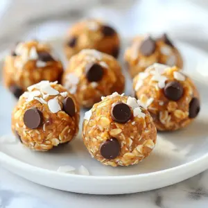 - 1 cup rolled oats - 1/2 cup natural peanut butter (or almond butter) - 1/3 cup honey or maple syrup - 1/2 cup protein powder - 1/4 cup mini dark chocolate chips - 1/4 cup chopped nuts - 1/4 cup unsweetened shredded coconut - 1 teaspoon vanilla extract - A pinch of sea salt You need these simple ingredients to make the best no-bake protein power balls. Rolled oats serve as the base. They add fiber and help keep you full. Peanut butter or almond butter provides healthy fats and protein. Honey or maple syrup gives sweetness and binds the mix together. Adding protein powder boosts your intake. You can use vanilla or chocolate flavors for extra taste. Mini dark chocolate chips offer a sweet touch. Chopped nuts add crunch and more nutrients. Unsweetened shredded coconut enhances texture and flavor. Vanilla extract rounds out the taste, and a pinch of sea salt balances the sweetness. - Different types of protein powder - Variations in nut types - Additional toppings like cacao powder Feel free to customize your power balls! You can use any type of protein powder you like. This way, you can change the taste. Try different nuts, such as almonds or walnuts, to switch up the crunch. You can also add toppings like cacao powder for a rich flavor boost. This flexibility allows you to create a snack that suits your tastes and needs. {{ingredient_image_2}} - Mixing dry ingredients: Start with a large bowl. Add 1 cup of rolled oats and 1/2 cup of protein powder. Stir until combined. This mix gives the base good texture and protein. - Combining wet ingredients: Next, add 1/2 cup of natural peanut butter and 1/3 cup of honey or maple syrup. Use a spatula to mix well. This step makes the mixture sticky and sweet. - Incorporating add-ins: Now, add 1/4 cup of mini dark chocolate chips, 1/4 cup of chopped nuts, and 1/4 cup of unsweetened shredded coconut. Also, add 1 teaspoon of vanilla extract and a pinch of sea salt. Stir until all ingredients are evenly mixed. This adds flavor and crunch. - Shaping the mixture: Scoop out small amounts of the mixture with your hands. Form each scoop into a ball about 1 inch wide. If it&rsquo;s too sticky, chill it in the fridge for 10 minutes. This makes shaping easier. - Setting in the refrigerator: Place the shaped balls on a baking sheet lined with parchment paper. Make sure they don&rsquo;t touch each other. Then, refrigerate for 30 minutes. This helps the power balls firm up. - How to store: After they are set, move the power balls to an airtight container. Keep them in the fridge. This keeps them fresh and tasty. - Duration of freshness: The power balls will last for up to one week in the fridge. Enjoy them as a quick snack or post-workout boost! To get the right texture for your protein power balls, adjust stickiness using refrigeration. If the mixture feels too sticky, chill it in the fridge for about 10 minutes. This makes it easier to roll into balls without the mess. When you form the balls, use your hands to scoop out the mix. Make each ball about 1 inch in size. This size is perfect for snacking. To make your protein power balls even tastier, try adding spices. A dash of cinnamon or a hint of nutmeg can bring new life to your mix. You can also experiment with different nut butters. Almond butter gives a nice twist, while sunflower seed butter is great for nut-free options. Each nut butter adds its own unique flavor. Enjoy these power balls as a quick snack or post-workout boost. They are also a sweet treat anytime! For a gourmet touch, drizzle melted dark chocolate on top. You can also roll them in cacao powder for added flavor. Pair these power balls with fresh fruit or yogurt for a balanced snack. Pro Tips Chill for Easy Handling: If the mixture is too sticky to form into balls, refrigerate it for about 10 minutes. This will make it easier to shape without mess. Customize Your Flavor: Feel free to experiment with different nut butters or add-ins like dried fruits or seeds for a personal touch and added nutrition. Keep Them Fresh: Store the power balls in an airtight container in the refrigerator to maintain their freshness for up to a week. Boost Nutrition: Add a tablespoon of flaxseeds or chia seeds to increase the omega-3 fatty acids and fiber content of your power balls. {{image_4}} To make vegan protein power balls, swap honey for maple syrup. Maple syrup gives a sweet taste without any animal products. You can also use almond butter instead of peanut butter. Almond butter adds a nutty flavor that pairs well with the oats. This version is perfect for those who follow a plant-based diet. For a low-carb version, choose sugar-free sweeteners like stevia or erythritol. These sweeteners keep the taste without adding extra carbs. Use a low-carb protein powder too, like whey isolate or plant-based blends. This way, you can enjoy the protein balls without worrying about carbs. Try mixing in chocolate and coconut for a tasty treat. Use dark chocolate chips and unsweetened shredded coconut. This combo offers a rich and satisfying flavor. Another popular mix is peanut butter with chocolate chips. The creamy peanut butter pairs well with the sweetness of chocolate. Both combinations keep the protein balls fun and exciting! Store your protein power balls in an airtight container. Glass or plastic containers work well. They stay fresh for up to one week in the fridge. To keep your power balls longer, freeze them. Place them in a single layer on a baking sheet first. Once frozen, transfer them to a freezer bag. They can last for up to three months. To enjoy, thaw them in the fridge overnight or at room temperature for a few hours. Check for changes in smell or texture. If they develop an off smell, toss them. Look for any signs of mold or unusual colors. These are clear signs that they are no longer good to eat. Protein power balls last about one week in the fridge. Store them in an airtight container. If you want to keep them longer, you can freeze them. They stay fresh in the freezer for about three months. Yes, you can use different protein powder flavors. Each flavor will change the taste of your power balls. For example, chocolate powder gives a sweet, rich taste. Vanilla powder offers a lighter, fresher flavor. Just remember, some flavors might add extra sugar or fat. Absolutely! These power balls are great for kids. They pack protein, healthy fats, and fiber. Kids love the taste, especially with chocolate chips. You can also make fun shapes or use colorful toppings to make them more appealing. To make these power balls gluten-free, use gluten-free rolled oats. Many brands offer gluten-free oats now. Check the label to ensure they are certified. This way, everyone can enjoy these tasty snacks without worries. In this post, we covered how to make delicious power balls with simple ingredients. We discussed required and optional add-ins, step-by-step instructions, and tips for great texture. You learned about variations and how to store them safely. These protein power balls are easy to customize. Feel free to experiment and find your favorite flavors. Enjoy making these healthy snacks that fit your taste and lifestyle!