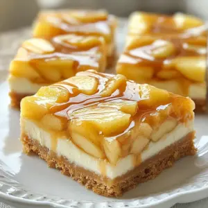 To make these tasty caramel apple cheesecake bars, you will need: - 2 cups graham cracker crumbs - 1/2 cup unsalted butter, melted - 1/4 cup granulated sugar - 2 (8-ounce) packages cream cheese, softened - 1 cup powdered sugar - 1 teaspoon pure vanilla extract - 2 large eggs, at room temperature - 2 cups apples, peeled, cored, and diced (preferably Granny Smith) - 1 teaspoon ground cinnamon - 1/2 cup caramel sauce (store-bought or homemade) - Optional: chopped nuts (such as pecans or walnuts) for topping You can easily swap some ingredients if needed. Here are some ideas: - Use coconut oil instead of butter for a dairy-free option. - If you don't have graham crackers, any plain cookie will work, like digestive biscuits. - For a lower sugar option, you can use a sugar substitute in the filling. - Any tart apple variety can replace Granny Smith, like Honeycrisp or Braeburn. Toppings can add a special touch. Try these options: - Drizzle extra caramel sauce on top for more sweetness. - Sprinkle chopped nuts for a nice crunch. - Add a dollop of whipped cream on each bar before serving. - A sprinkle of sea salt can enhance the caramel flavor. These small changes can make your dessert unique and fun! {{ingredient_image_2}} Start by preheating your oven to 350&deg;F (175&deg;C). This step is key for even baking. Next, take a 9x13 inch baking dish and line it with parchment paper. Make sure some paper hangs over the edges. This helps you lift the bars out later. In a medium bowl, mix 2 cups of graham cracker crumbs with 1/2 cup of melted butter and 1/4 cup of granulated sugar. Stir until it looks like wet sand. Press this mix firmly into the bottom of your baking dish. You want it smooth and even. In a larger bowl, beat 2 packages of softened cream cheese with an electric mixer. Mix it until it&rsquo;s smooth and creamy. Slowly add 1 cup of powdered sugar and 1 teaspoon of pure vanilla extract. Keep mixing until it&rsquo;s fluffy and well combined. Take 2 cups of diced apples and toss them in 1 teaspoon of ground cinnamon. This adds a warm flavor. Gently fold this apple mix into the cheesecake batter. Be careful not to overmix. You want to keep the nice chunks of apple. Pour the apple cheesecake mix over the cooled crust. Spread it evenly with a spatula. Next, drizzle 1/2 cup of caramel sauce over the top. Use a toothpick to swirl the caramel into the cheesecake. Bake it in the oven for 30 to 35 minutes. The center should have a slight jiggle when done. Once baked, let it cool completely. Then, refrigerate for at least 3 hours before cutting. To get a smooth cheesecake, make sure your cream cheese is soft. Let it sit out for about 30 minutes before mixing. Beat the cream cheese well until it is fluffy. Add eggs one at a time, mixing well after each. This helps to keep the batter light and airy. Granny Smith apples work best for this recipe. They are tart and hold their shape well when baked. You can also try Honeycrisp apples for a sweeter touch. Always peel and core the apples. Then, dice them into small pieces. This ensures every bite has apple goodness. When you drizzle caramel over the cheesecake, use a light hand. Pour it in a zigzag pattern across the top. Then take a toothpick or knife to swirl it. Don&rsquo;t over-swirl; you want to see both caramel and cheesecake. This creates a stunning marbling effect. Pro Tips Use Room Temperature Ingredients: Ensure your cream cheese and eggs are at room temperature before mixing. This helps achieve a smoother and creamier batter without lumps. Choose the Right Apples: Granny Smith apples are ideal for this recipe due to their tartness, which balances the sweetness of the caramel and cheesecake. Swirl the Caramel: When swirling the caramel into the cheesecake layer, use a gentle hand to create beautiful marbled patterns without overmixing the batter. Chill Before Serving: For best texture and flavor, refrigerate the cheesecake bars for at least 3 hours or overnight. This allows the bars to set properly and enhances the taste. {{image_4}} You can make mini versions of these bars. Use a mini muffin tin to create bite-sized treats. Press the graham cracker crust into each cup. Fill them with the cheesecake mixture and diced apples. Bake just like the bars, but for a shorter time. These bites are perfect for parties or snacks. If you want to change the flavor, try adding nutmeg or cloves. Just a pinch will add depth. Mix these spices into the apple mixture or the cheesecake batter. This small change can give your bars a whole new taste. It&rsquo;s a fun way to switch things up! To make these bars gluten-free, swap out the graham crackers. Use crushed gluten-free cookies or almond flour mixed with melted butter. This will give you a tasty crust without gluten. It&rsquo;s a simple swap that keeps the joy of these caramel apple cheesecake bars. To keep your caramel apple cheesecake bars fresh, store them in the fridge. Use an airtight container to prevent drying out. Make sure they are fully cooled before covering them. These bars will stay tasty for about five days in the fridge. You can freeze these bars for up to three months. First, cut them into squares. Wrap each piece in plastic wrap. Then, place them in a freezer-safe bag or container. This way, they stay fresh and ready for a sweet treat anytime. When you are ready to enjoy your frozen cheesecake bars, take them out of the freezer. Move them to the fridge and let them thaw overnight. If you're in a hurry, you can leave them at room temperature for about 30 minutes. Once thawed, serve them chilled. They taste best when cold, and you can add more caramel or nuts if you like! Caramel Apple Cheesecake Bars can last about 5 days in the fridge. Make sure to store them in an airtight container. This keeps them fresh and tasty. If you want them to last longer, you can freeze them. They can stay good in the freezer for up to 3 months. Yes, you can use store-bought caramel sauce. It saves time and still tastes great. Just drizzle it over the cheesecake before baking. If you prefer a homemade touch, you can also make your own caramel sauce. Both options work well for this recipe. To cut cheesecake bars, use a sharp knife. Dip the knife in hot water for a few seconds, then wipe it dry. This helps create clean cuts. You can also score the cheesecake lightly before cutting. This guide makes cutting easier and neater. Yes, you can make these cheesecake bars ahead of time. They are perfect for parties or gatherings. Make them a day before and chill them overnight. This allows the flavors to blend well and the bars to set properly. To sum up, this post covered all you need to make delicious Caramel Apple Cheesecake Bars. You learned about key ingredients and how to substitute them. I shared step-by-step instructions to guide you through baking. The tips and tricks help ensure your bars have the perfect texture. Additionally, I provided fun variations to try and storage tips for fresh treats. Enjoy your baking adventure! It&rsquo;s time to impress your friends and family.